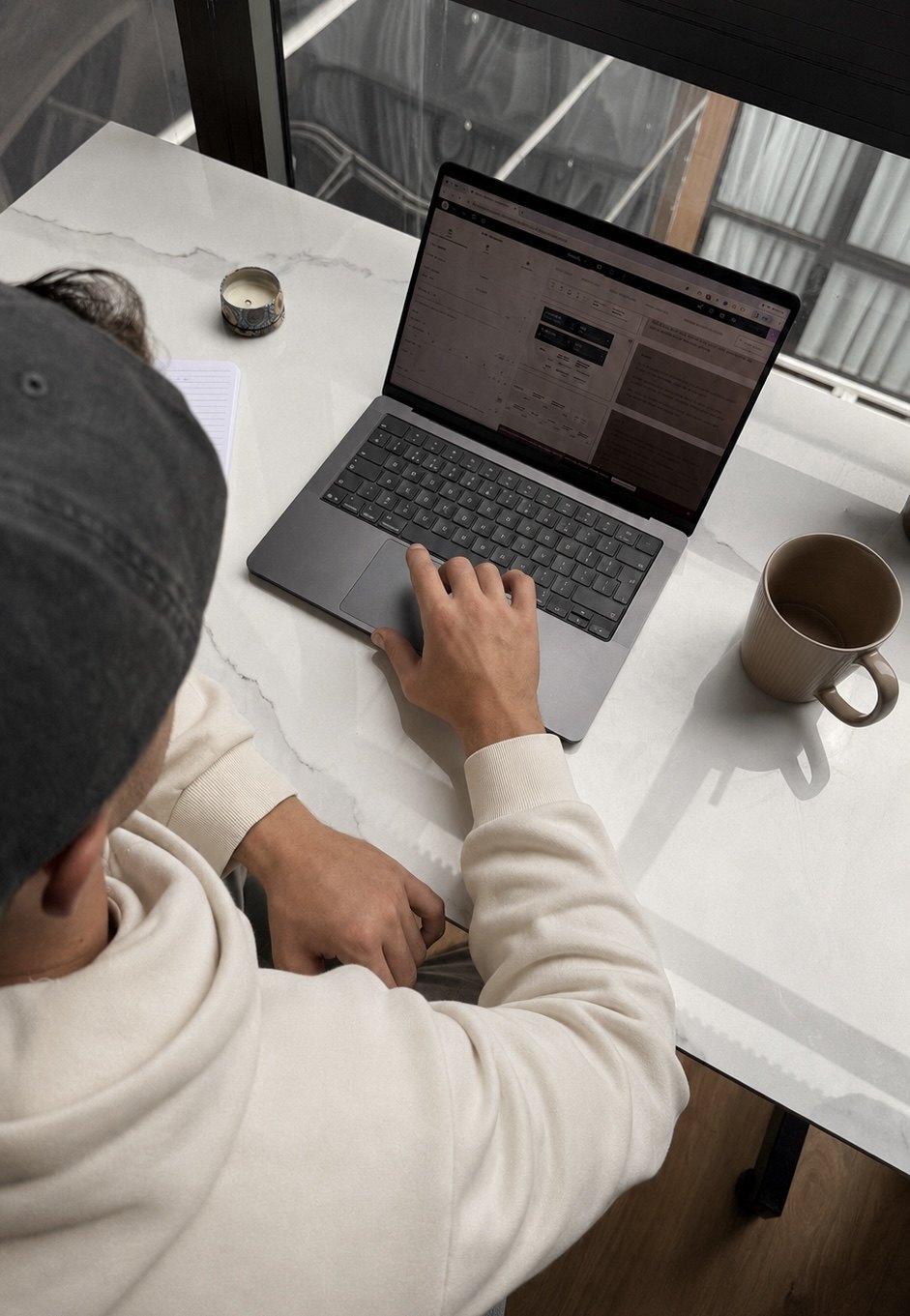 Richard Dineen designing a website layout on his laptop